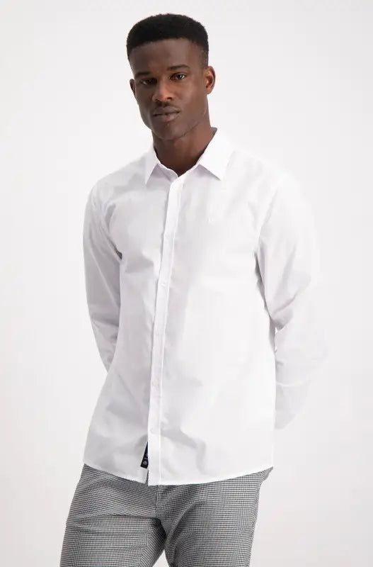 Men’s white long-sleeved button-up shirt with gray striped pants.