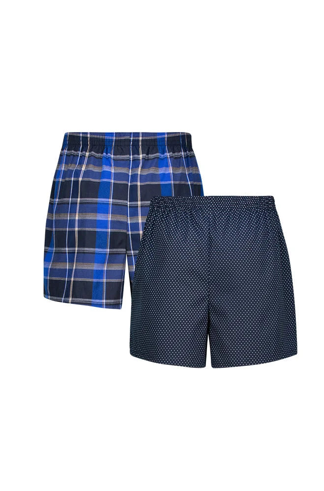 Two pairs of men’s woven boxers, one blue plaid and one navy with small white dots.