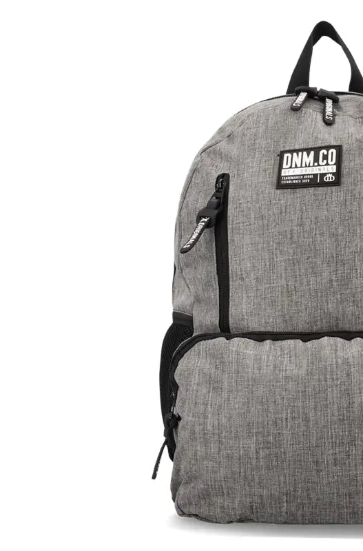 Half view of a gray fabric backpack with black zippers and straps