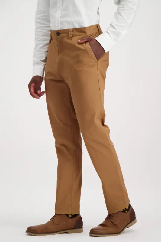 Men’s slim-fit tan chinos with brown lace-up shoes.
