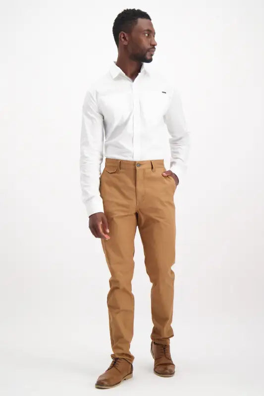 Men’s white long-sleeve button-up shirt and brown pants.