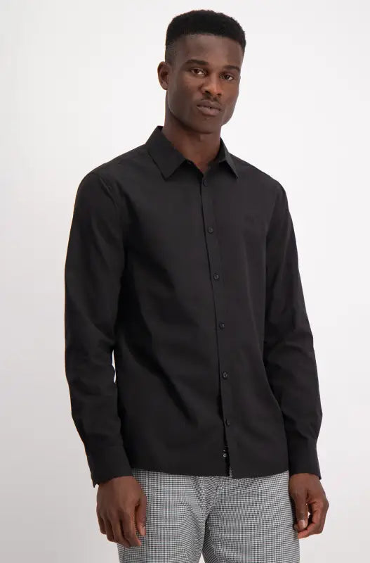 Men’s long-sleeved black button-up shirt.