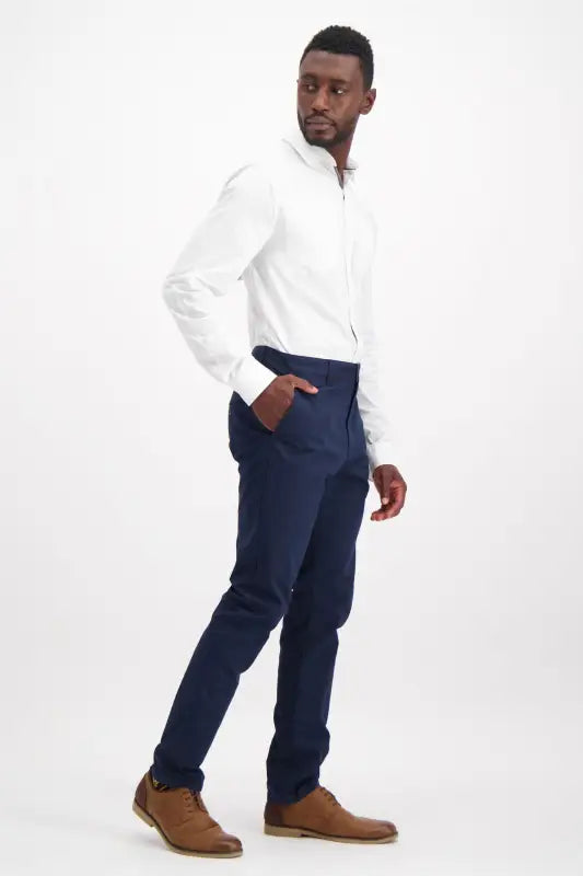 Men’s white long-sleeve dress shirt and navy blue trousers.