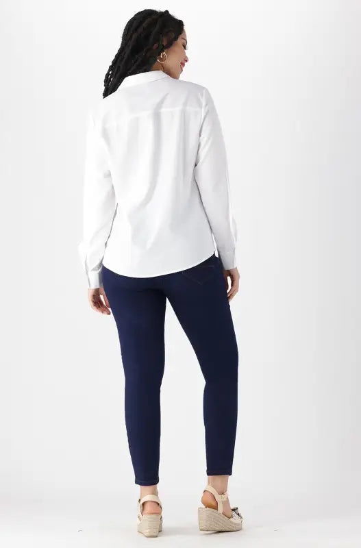 Women’s white button-up shirt and navy blue pants outfit.