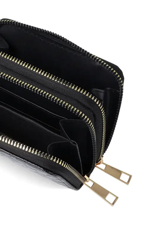 An open black zippered wallet with multiple compartments and gold-colored zipper pulls.