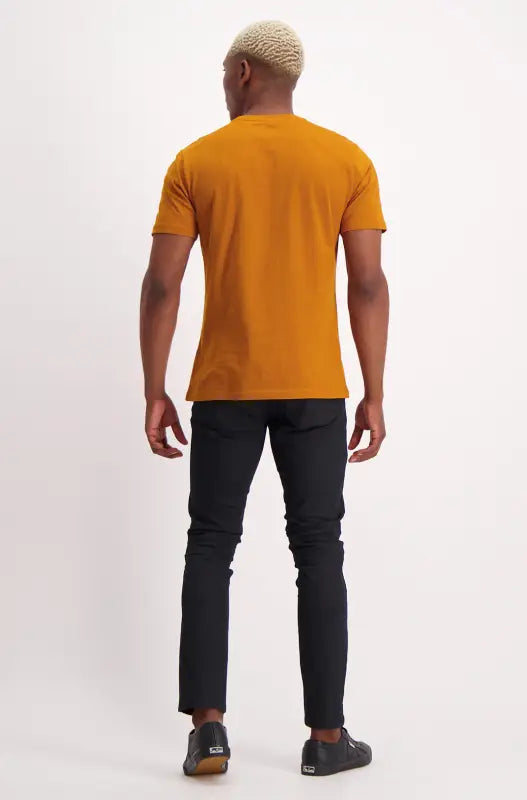 Men’s mustard yellow short-sleeved t-shirt and black pants.