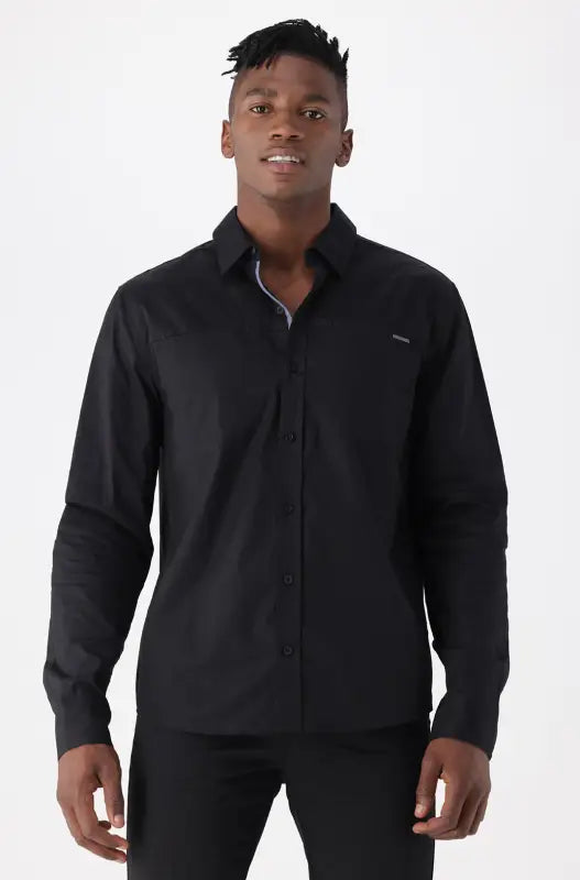 A long-sleeved black button-up shirt with a classic collar.