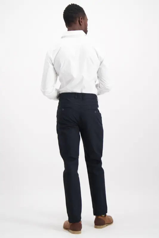 Men’s white long-sleeve collared shirt and navy blue pants.