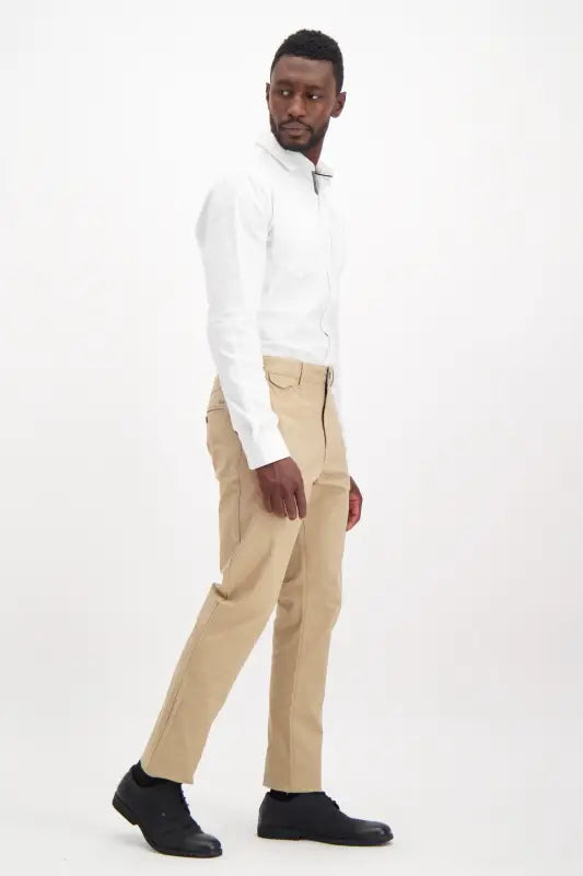 Men’s white long-sleeve collared shirt and tan pants.