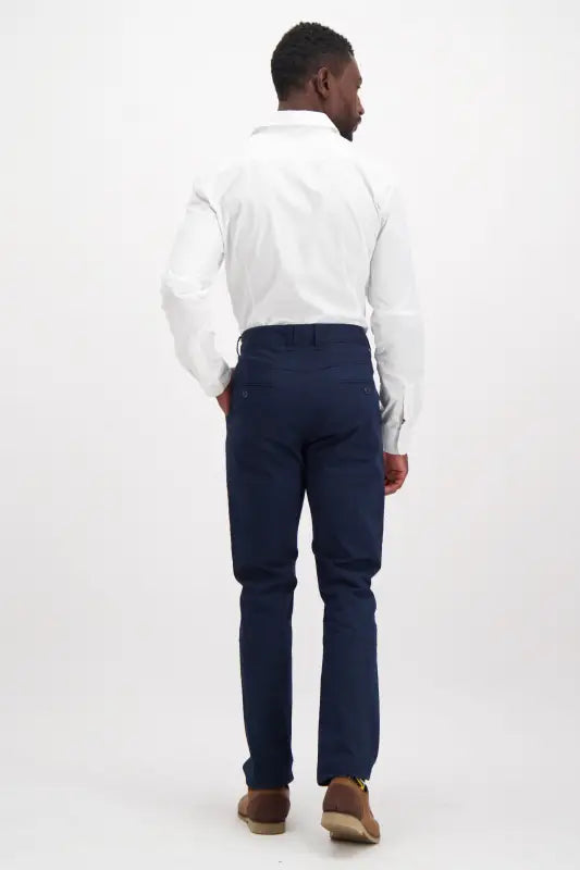 Men’s white long-sleeved dress shirt and navy blue pants.