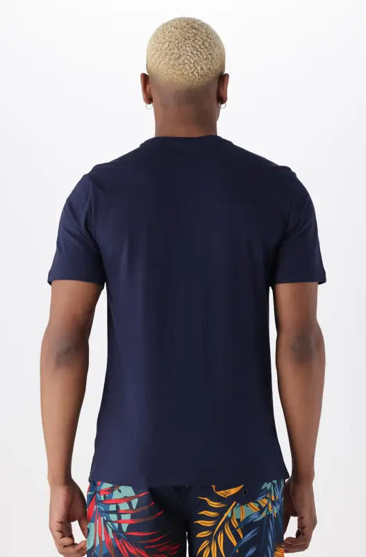 Men’s navy blue short-sleeved t-shirt with tropical print shorts.