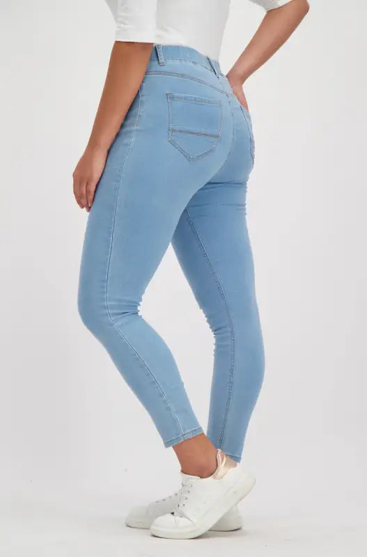 Light blue skinny jeans with decorative stitching on the back pockets.