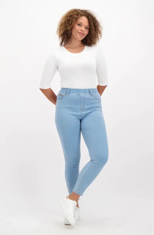 Light blue women’s stretch skinny jeans with an elastic waistband.