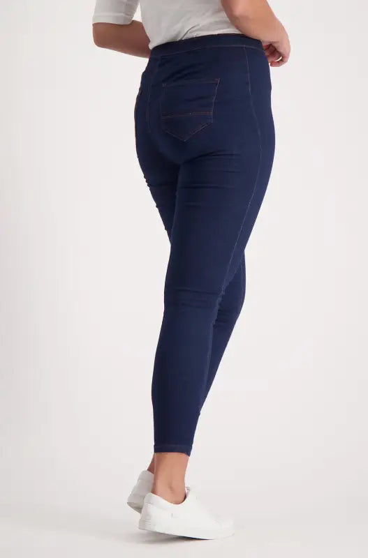 A pair of navy blue full-length women’s jeggings.