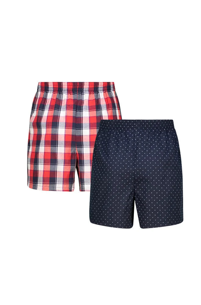 A pair of men’s woven boxers, one in a red and white plaid pattern and the other in a navy blue with white polka dots.