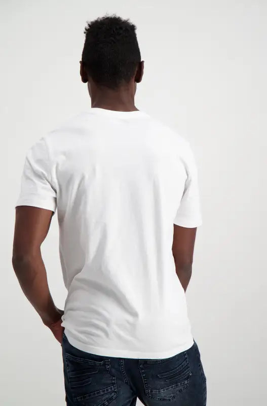 Men’s white crew-neck t-shirt and dark wash jeans