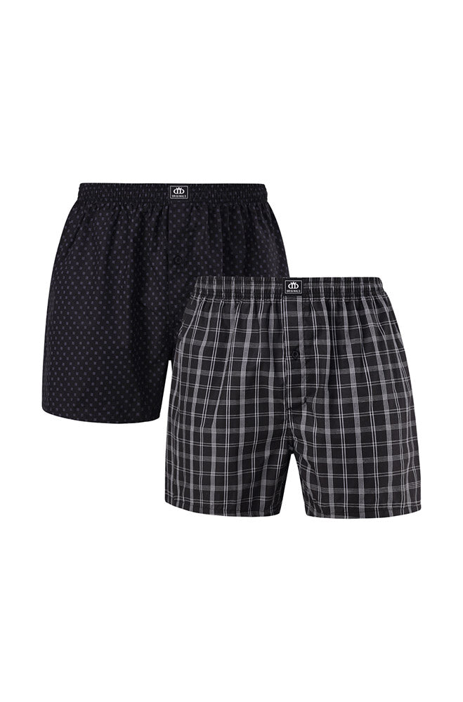 A two-pack of men’s woven boxers, one black with a subtle pattern and one black and white plaid.
