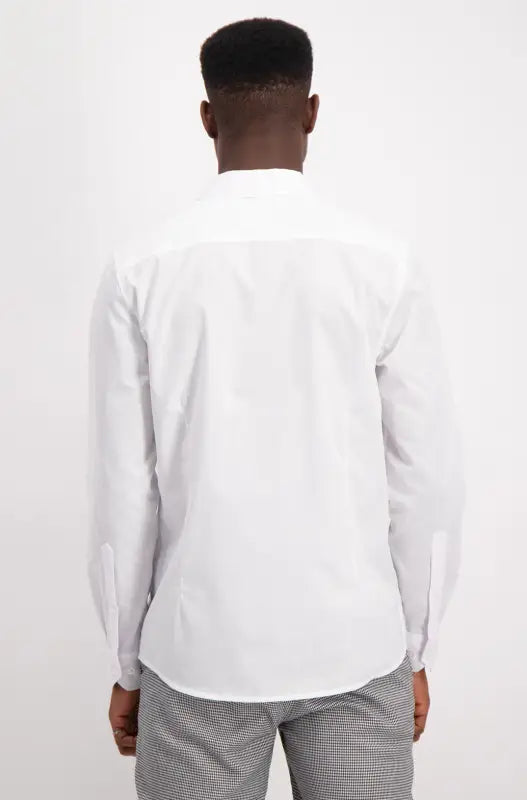 Men’s white long-sleeved button-up shirt with a curved hem.