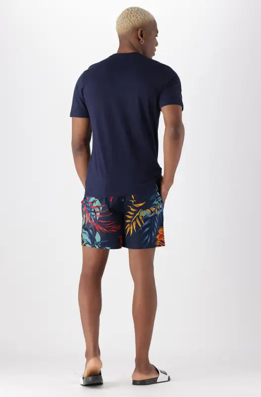 Men’s navy blue t-shirt and tropical print shorts set.